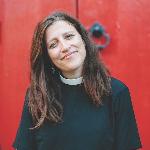 Tish Harrison Warren standing in front of a church door.